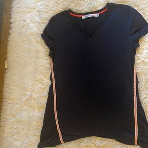 Navy blue cotton tshirt with coral and white stitching. Has an A-line style